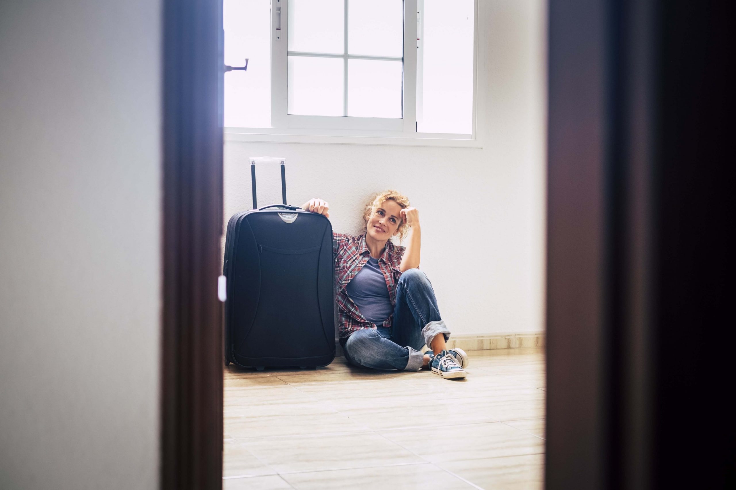 one woman sit down alone inside empty home with lu X89MLMH min 1 scaled