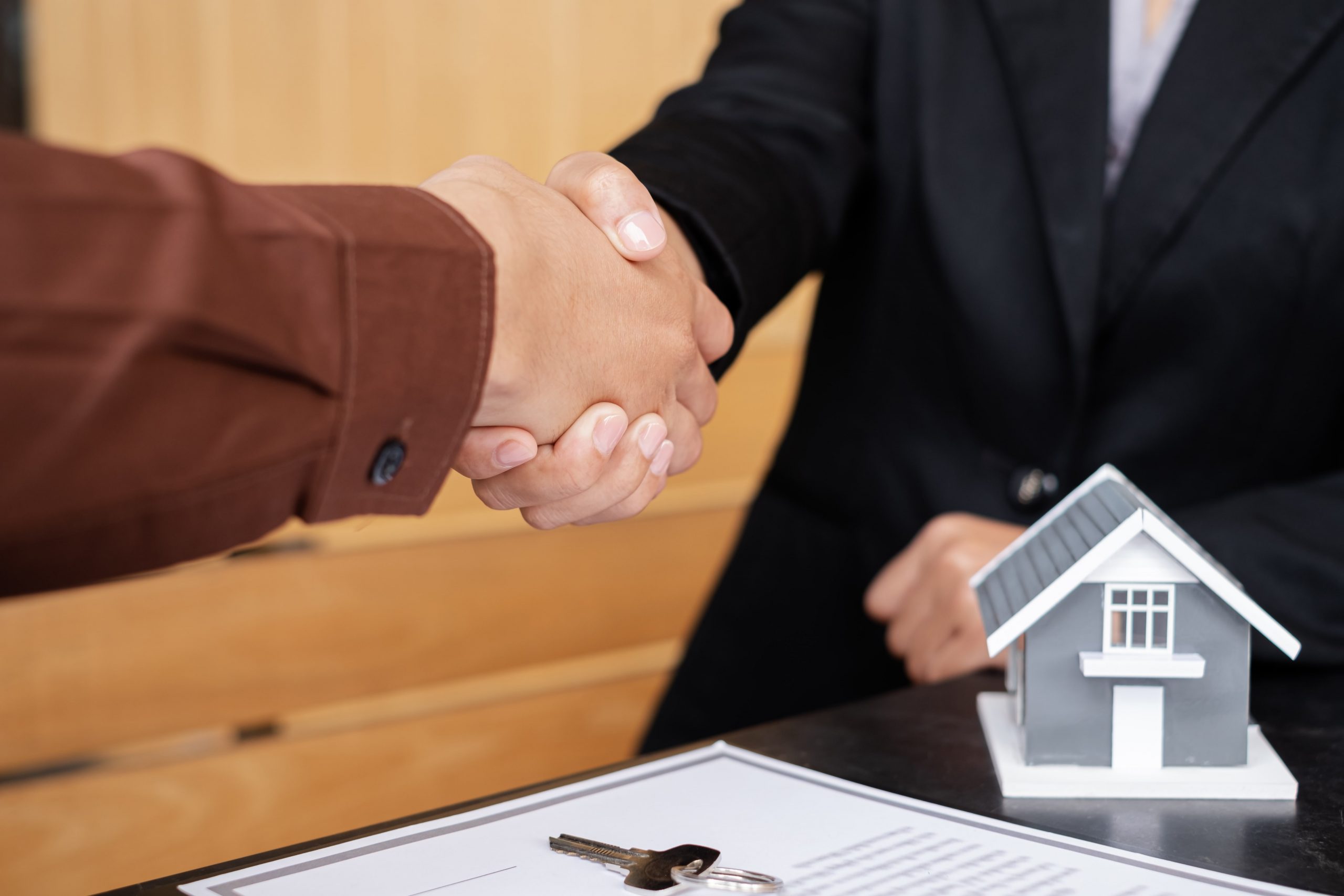 businessmen and brokers real estate agents shake h Z73RE8D min scaled