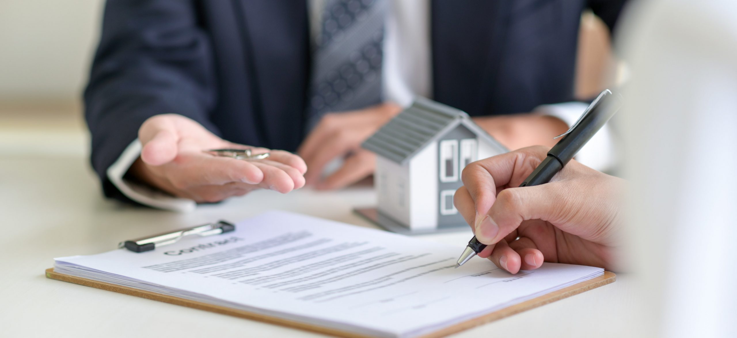 signing a loan for a home purchase CVQDFTV min scaled 1